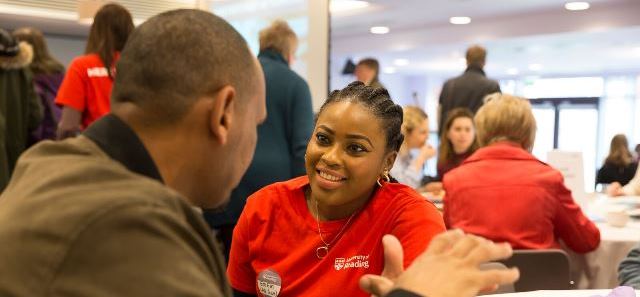 Postgraduate student ambassador chatting to a prospective student 
