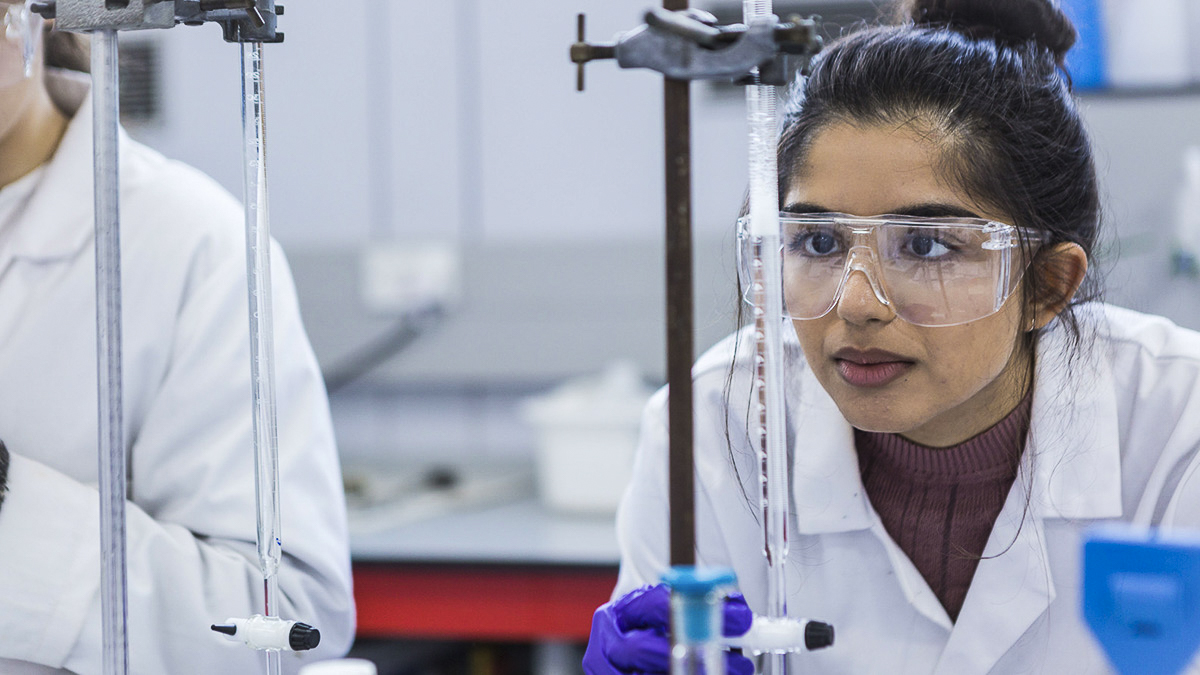 A student measuring the results of an experiment
