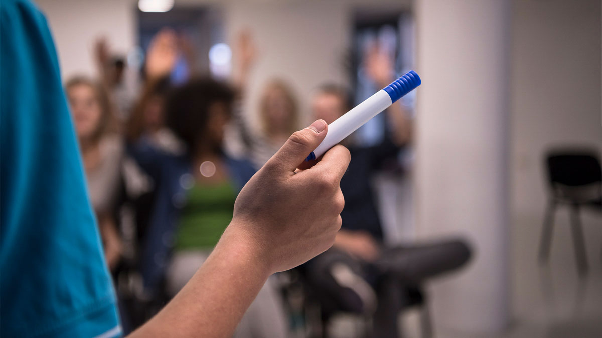 Lecturer pointing with board pen