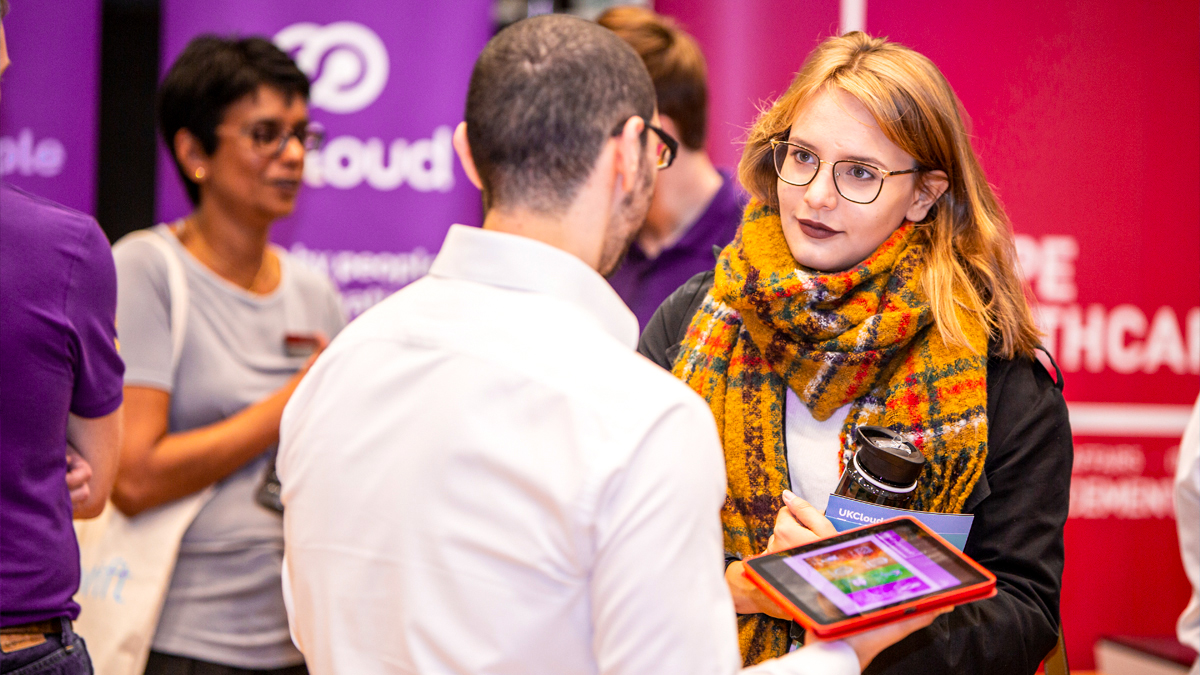 A student talking to an employer at a job fair