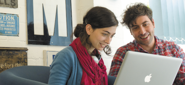 Students looking at a laptop