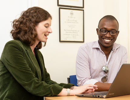 A man and woman working on a laptop