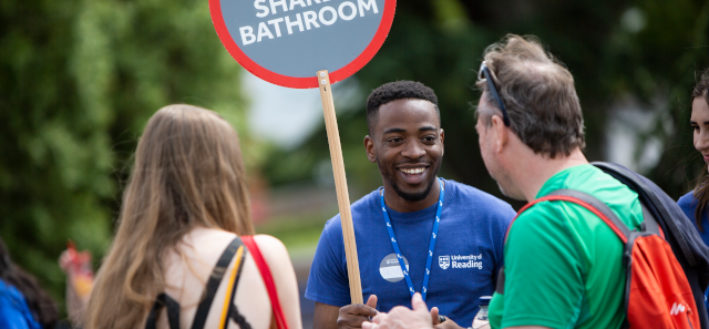 Student talking to two people. 
