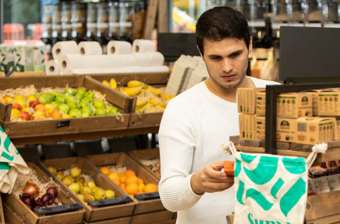 Man in the fruit aisle of a shop